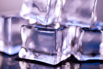 Ice cubes on a blue background. Ice on a blue background