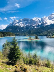 Beautiful green turquoise lake in the mountains with snow peaks, clouds in the sky 