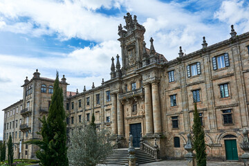 Fototapeta premium A view of the facade of the Monastery of San Martin Pinario or San Martiño Pinario at historical center of Santiago de Compostela, Galicia, Spain, under blue cloudy sky.