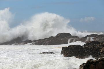 Big wave splash against blue sky