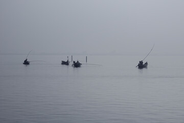 Naklejka premium Traditional fishing boats during toil