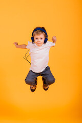 Portrait of happy little boy over yellow background