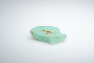 Natural chrysoprase stone on a white background