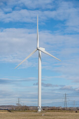 Renewable energy wind turbine in a field