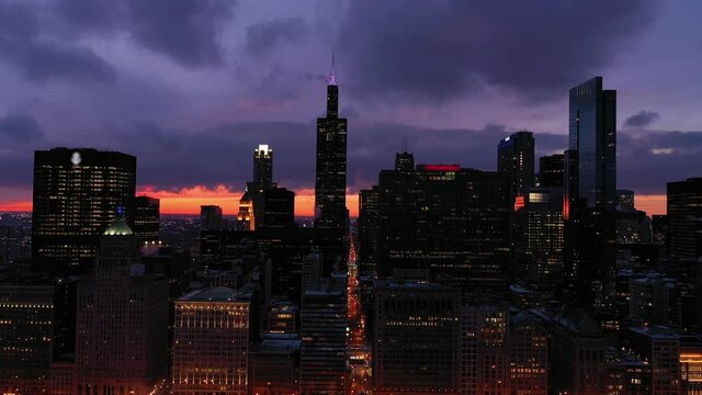 Urban Skyline of Chicago Loop in Blue Hour in Winter. Evening Twilight. Aerial View. United States of America. Drone Flies Backwards. Medium Shot