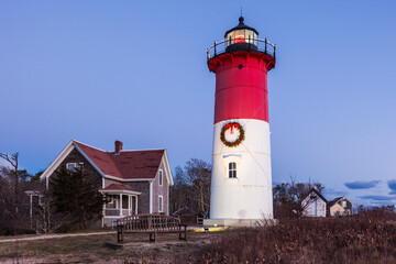 USA, Massachusetts, Cape Cod, Eastham. Nauset Light with Christmas wreath at dawn.