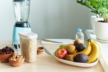 Morning vegan breakfast , making smoothies for detox and proper nutrition from fresh vegetables and fruits. Spinach with avocado and banana, green smoothie drink