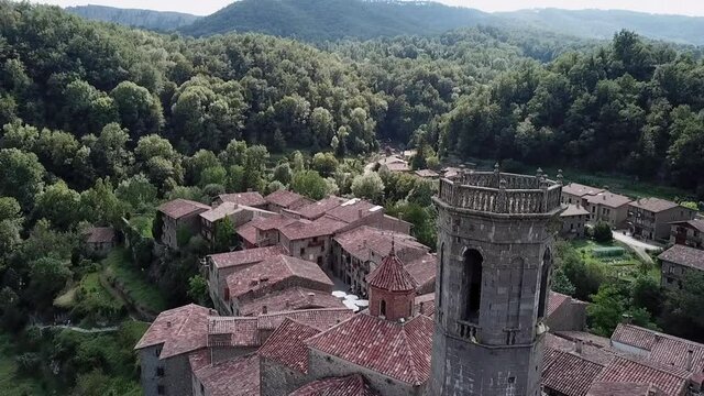 Aerial Backward: Tower Amidst Residential Structures In Town
