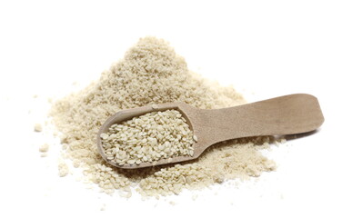 Pile sesame protein powder and seeds in wooden spoon isolated on white background 