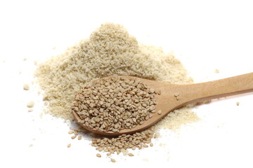 Pile sesame protein powder and integral seeds in wooden spoon isolated on white background 