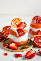 Layered trifle dessert with blood oranges cream Kurd, greek yogurt, Savoyardi cookies, orange chips...