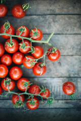 red cherry tomatoes on wooden background