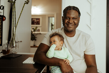 Young African parent with his baby.