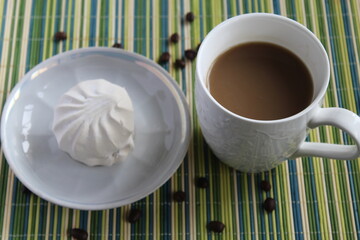 marshmallow on the table with cup of coffee and milk
