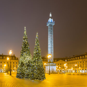 France, Ile-de-France, Paris, Christmas trees at illuminated Place Vendome during night