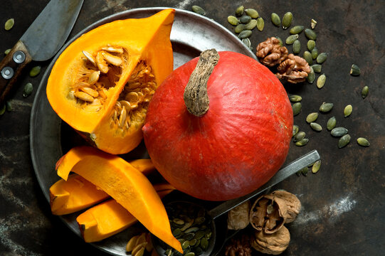 Walnuts, pumpkin seeds and red&Ocirc;&oslash;&Omega;kuri&Ocirc;&oslash;&Omega;squashes on rustic baking sheet