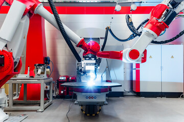 Automatic robots welding metal in factory