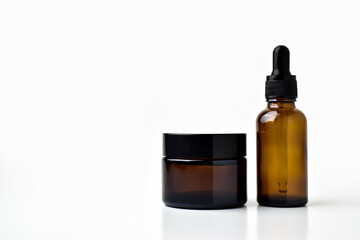 Glass jars for cosmetics are isolated on a white background. There is a copy of the space. Empty, clean bottles for presentation.