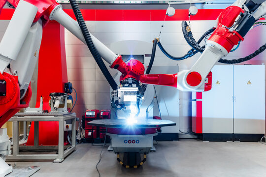 Automatic robots welding metal in factory