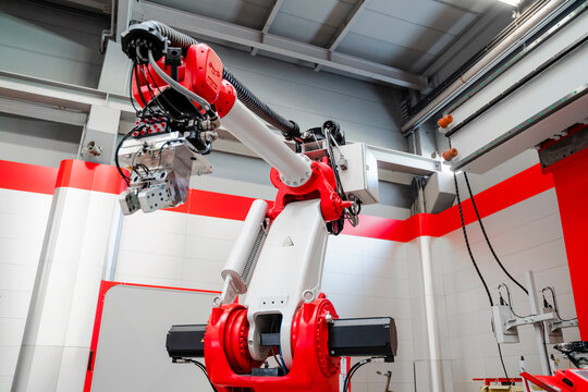 Low angle view of industrial welding robot arm in factory
