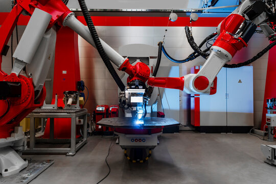 Automatic robots welding metal in factory