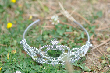 discarded plastic tiara on the ground © eugen