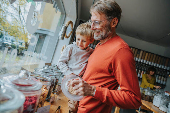 Father and son shopping together in zero waste store