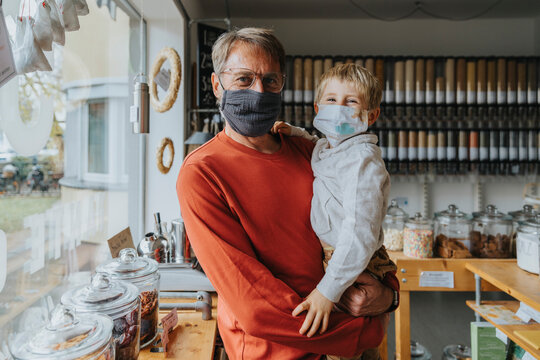 Father and son standing in zero waste store during COVID-19