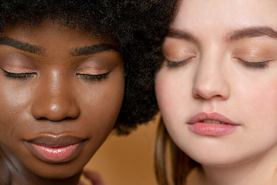 Multi-ethnic female model friends with eyes closed