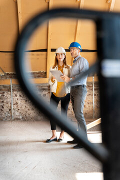 Expertise team using digital tablet while examining at construction site