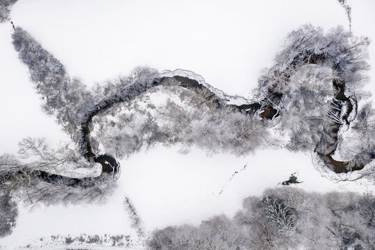Drone view of meandering stream in winter