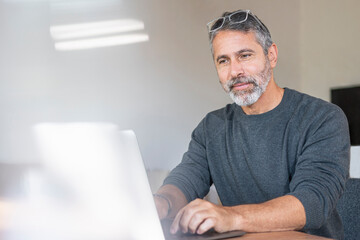 Professional working on laptop while sitting at home