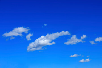 White clouds are on a clear blue sky