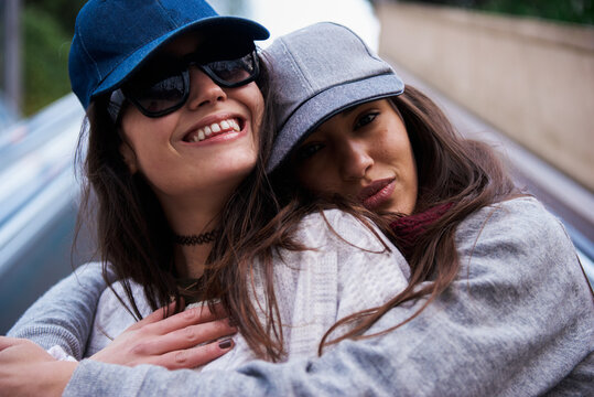 Pretty girlfriends in baseball caps.