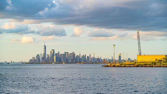 Beautiful waterfront, sky and clouds during sunset, view on Gravesend Bay in Brooklyn and Manhattan, New York