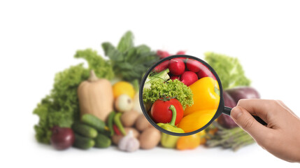 Woman with magnifying glass exploring vegetables, closeup. Poison detection