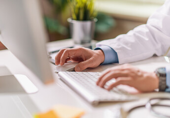 Male doctor working in office