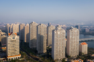 Fototapeta na wymiar Aerial view of modern city skyline beside the river at sunrise in Jimei District, Xiamen, China