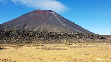 View to Mount Ngauruhoe and a yellow desert in front of it. Tongariro National Park, New Zealand