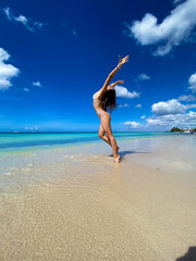 Fototapeta na wymiar Sexy bikini body woman on paradise tropical beach having fun. Concept of wellness and travel
