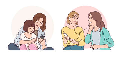 Mother and daughter are looking at cell phones. Friends who listen to music on their mobile phones.