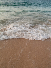 Waves breaking on the shore at dusk delicate pastel colours of the caribbean sea 