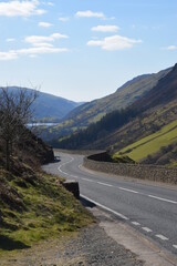 a steep and dangerous road near Cadair Idris with mountains either side and tal-y-llyn lake in the background
