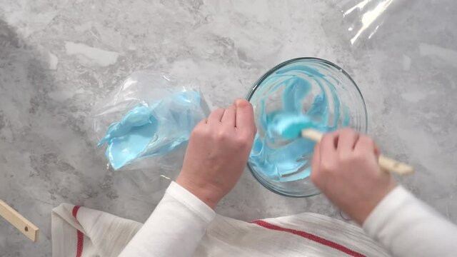 Time lapse. Flat lay. Step by step. Transfering meringue mix into piping bags with metal tips to bake unicorn meringue pops cookies.