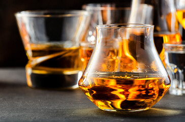 Hard strong alcoholic drinks and distillates in glasses in assortment: vodka, cognac, tequila,...