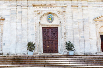 Marble stairs and wooden door of cathedral . Entrance with large wooden door on the cathedral