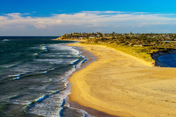 Port Noarlunga beach with people at sunset, South Australia