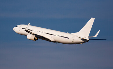 Fototapeta na wymiar View of commercial jet taking off in blue sky