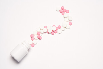 White jar with pills on a light background top view medicine health vitamins