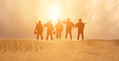 Silhouette Of A Solider Saluting Against the Sunrise in desert . Concept - armed forces of Islam...
